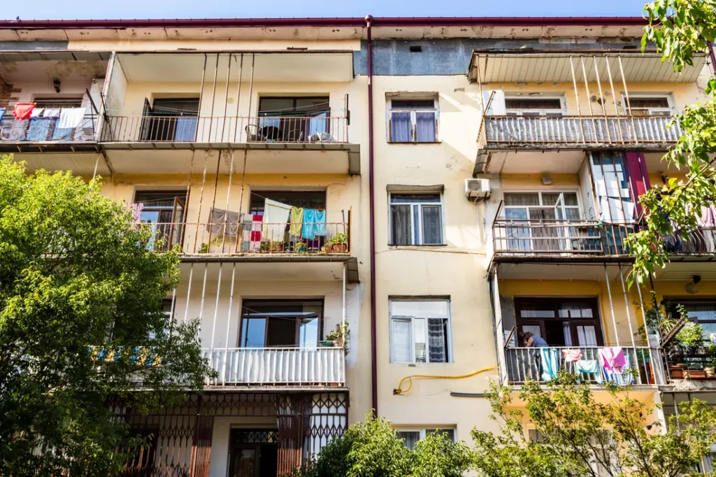 An apartment building with balconies and plants