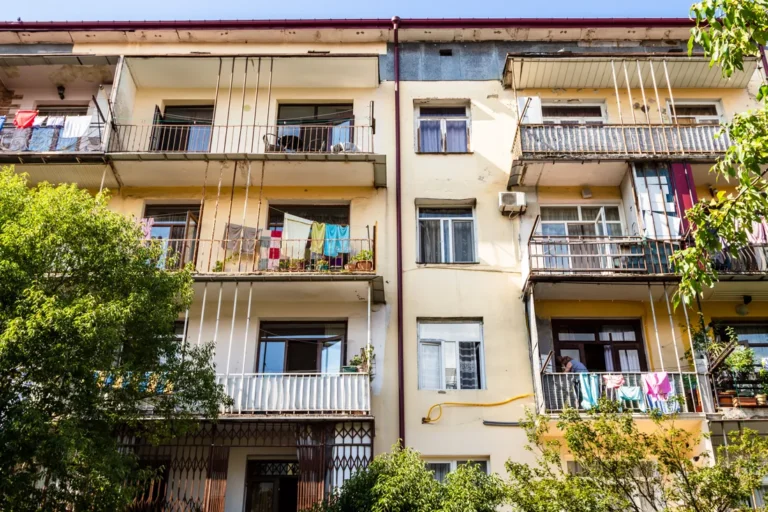 An apartment building with balconies and plants